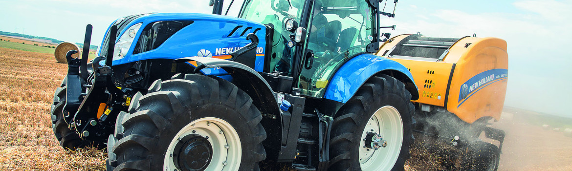 A 2019 New Holland tractor towing a New Holland baler
